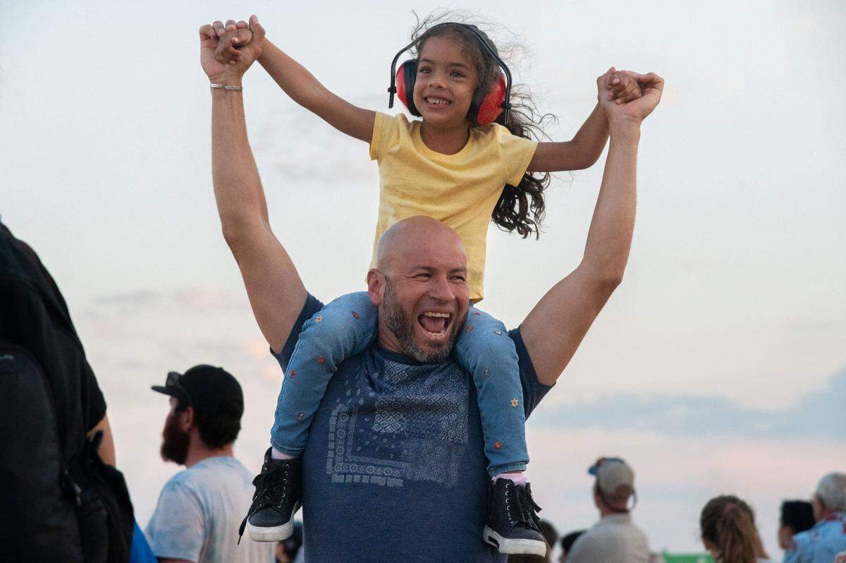Victor Rodriguez dances with his 5-year-old daughter, Sofia, on his shoulders during the California Capital Airshow at Mather Airport near Rancho Cordova on Saturday, July 13, 2024. Connie Rodriguez, Sofia’s mother, said her daughter’s favorite part of the day was when the U.S. Air Force Thunderbirds created a heart during their performance.
