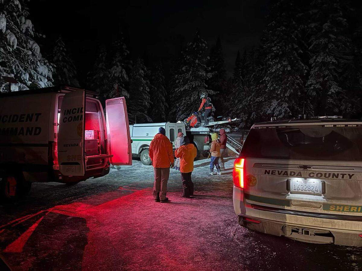Nevada County Search and Rescue team members congregate beside an incident command van and SnowCat in Nevada County, Calif., on Monday, Jan. 5, 2026. An avalanche struck a popular snowmobiling area Monday afternoon, prompting an emergency response involving about 45 personnel from multiple agencies.