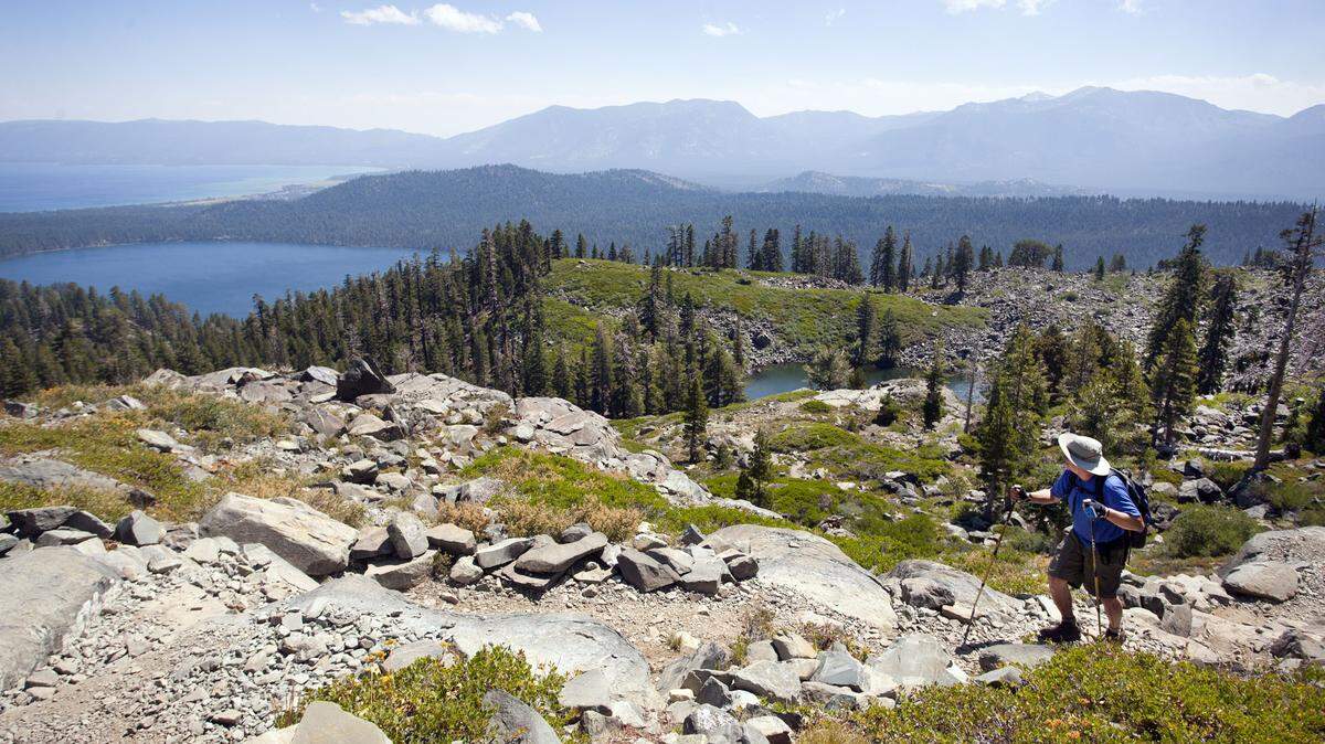 A hiker peers back toward Fallen Leaf Lake as he makes his way up the trail to the summit of Mt. Tallac on July 31, 2013 in Lake Tahoe.