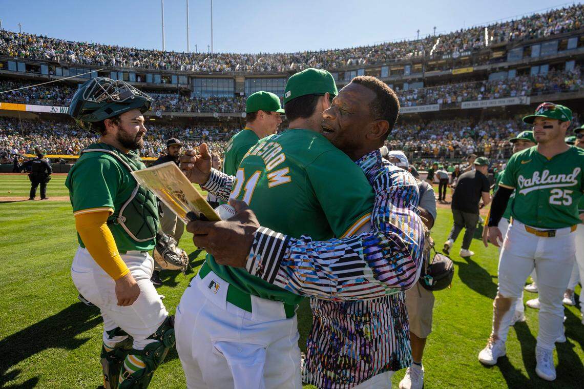 The Oakland Athletics’ Tyler Soderstrom (21) embraces former player Ricky Henderson, giving Henderson the ball used in the final out against the Texas Rangers, following the A’s final game in Oakland on Thursday.