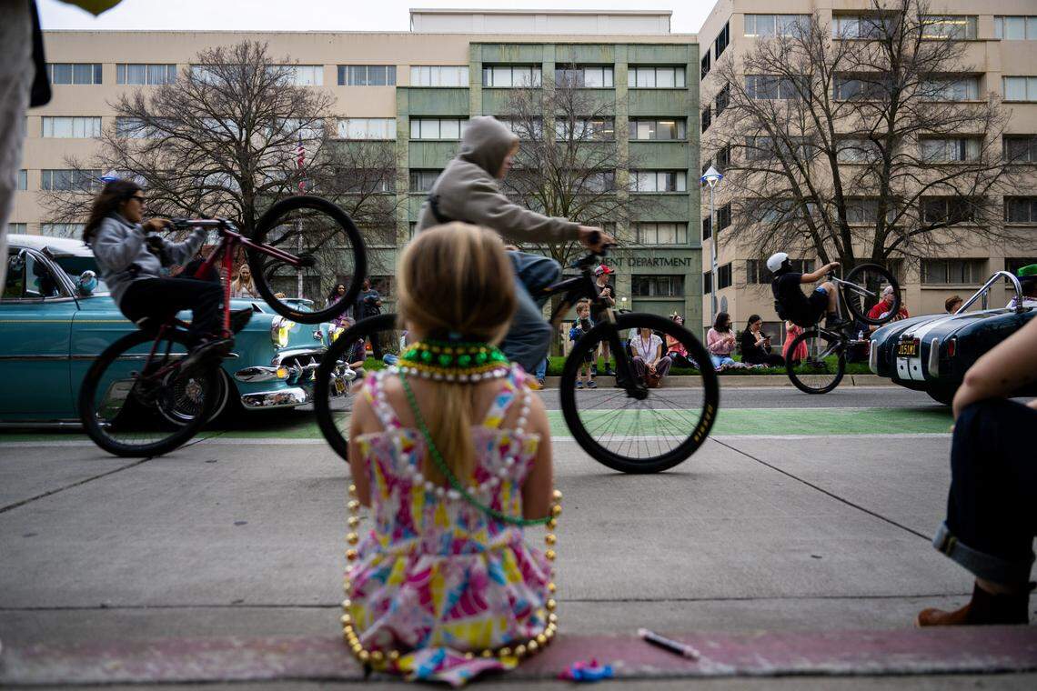 Ava Beauton, 5, of Sacramento watches bicyclists ride down Capitol Mall during the City of Trees Parade on Saturday, Feb. 28, 2026.