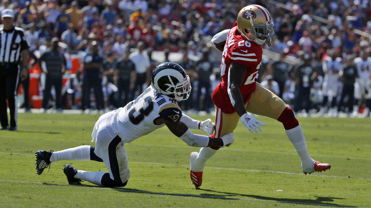 San Francisco 49ers running back Tevin Coleman (26) score past Los Angeles Rams strong safety John Johnson during the first half of an NFL football game Sunday, Oct. 13, 2019, in Los Angeles. (AP Photo/John Locher )
