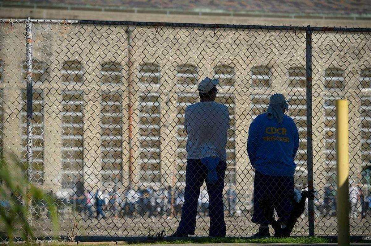 Inmates stand in the main exercise yard at Folsom State Prison in 2017. Proposition 57 gave some inmates early parole opportunities and more chances to shave down their sentences through credit-earning.