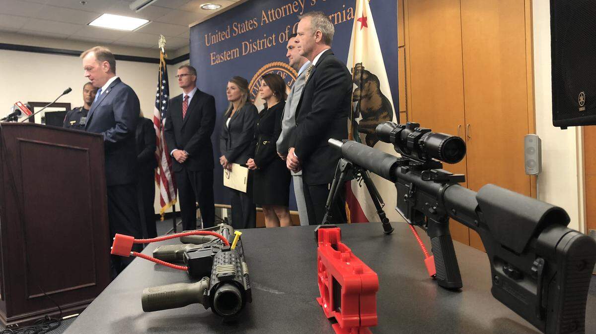 Flanked by two AR-15-style “ghost guns” seized by federal agents, U.S. Attorney McGregor Scott discusses efforts to curb violent crime in Northern California at a press conference Oct. 3, 2018, in his Sacramento office.