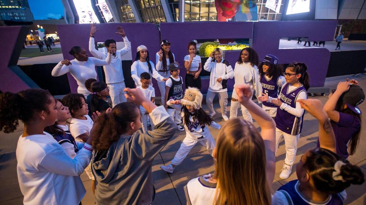 Melody Eller, 9, wears a lion hat while freestyle dancing in a circle of fellow dancers with Balance Dance Project, directed by Heather Singleteary, at DoCo during the NBA basketball game between the Sacramento Kings and the Golden State Warriors on Friday, April 7, 2023, at Golden 1 Center. Excitement for the Kings’ last home game of the regular season was only eclipsed by anticipation for the team’s first playoff berth in 16 years.