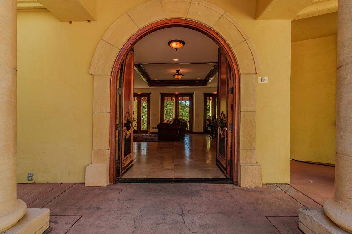 Imported Brazilian front doors, hand-crafted steelwork, and custom tilework throughout add artistic flair and distinction.