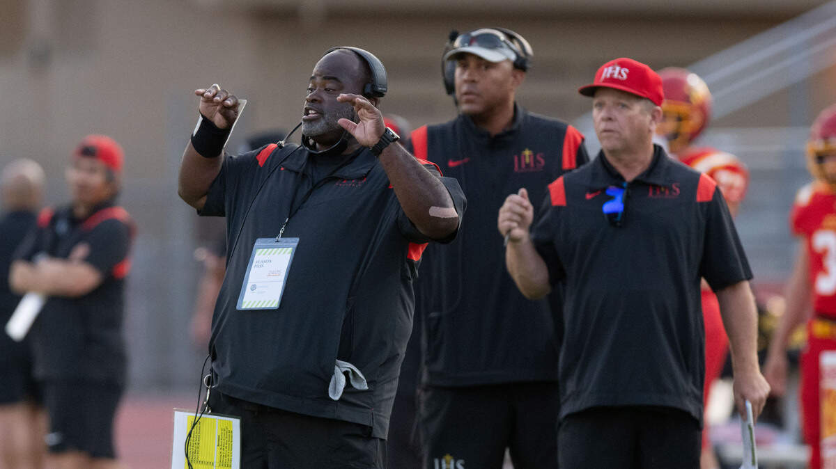 Jesuit coach Marlon Blanton communicates with his players during a timeout against Rio Americano on Friday at Jesuit High School in Carmichael.