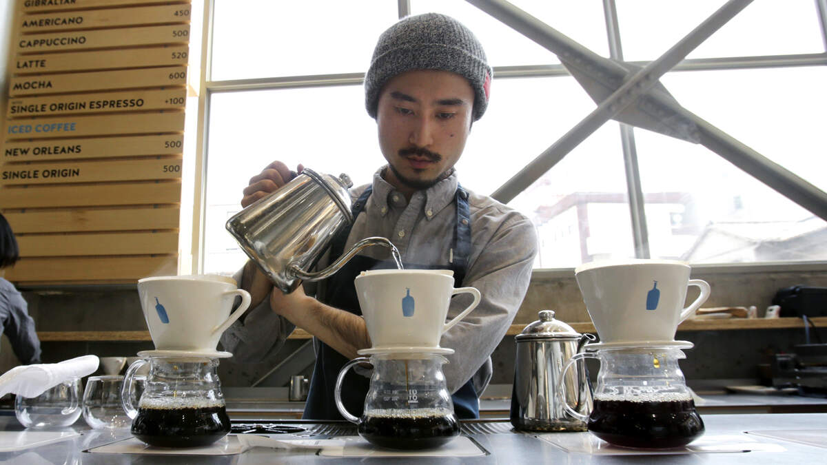 A barista brews coffee at a Blue Bottle Coffee shop in Tokyo in 2015. The Oakland-based company has expanded throughout the Bay Area, Los Angeles, four East Coast cities and Japan. Could Sacramento soon join the list?