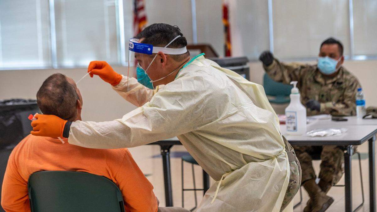 California National Guard Spc. David Miyake conducts a COVID-19 test inside a Natomas Unified School District building on Tuesday, July 14, 2020.