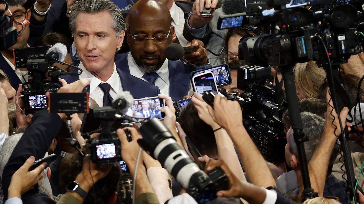 Gov. Gavin Newsom (D-CA) and Sen. Raphael Warnock (D-GA) speak to reporters in the spin room following the CNN Presidential Debate between U.S. President Joe Biden and Republican presidential candidate, former U.S. President Donald Trump at the McCamish Pavilion on the Georgia Institute of Technology campus on June 27, 2024, in Atlanta, Georgia. (Kevin Dietsch/Getty Images/TNS)