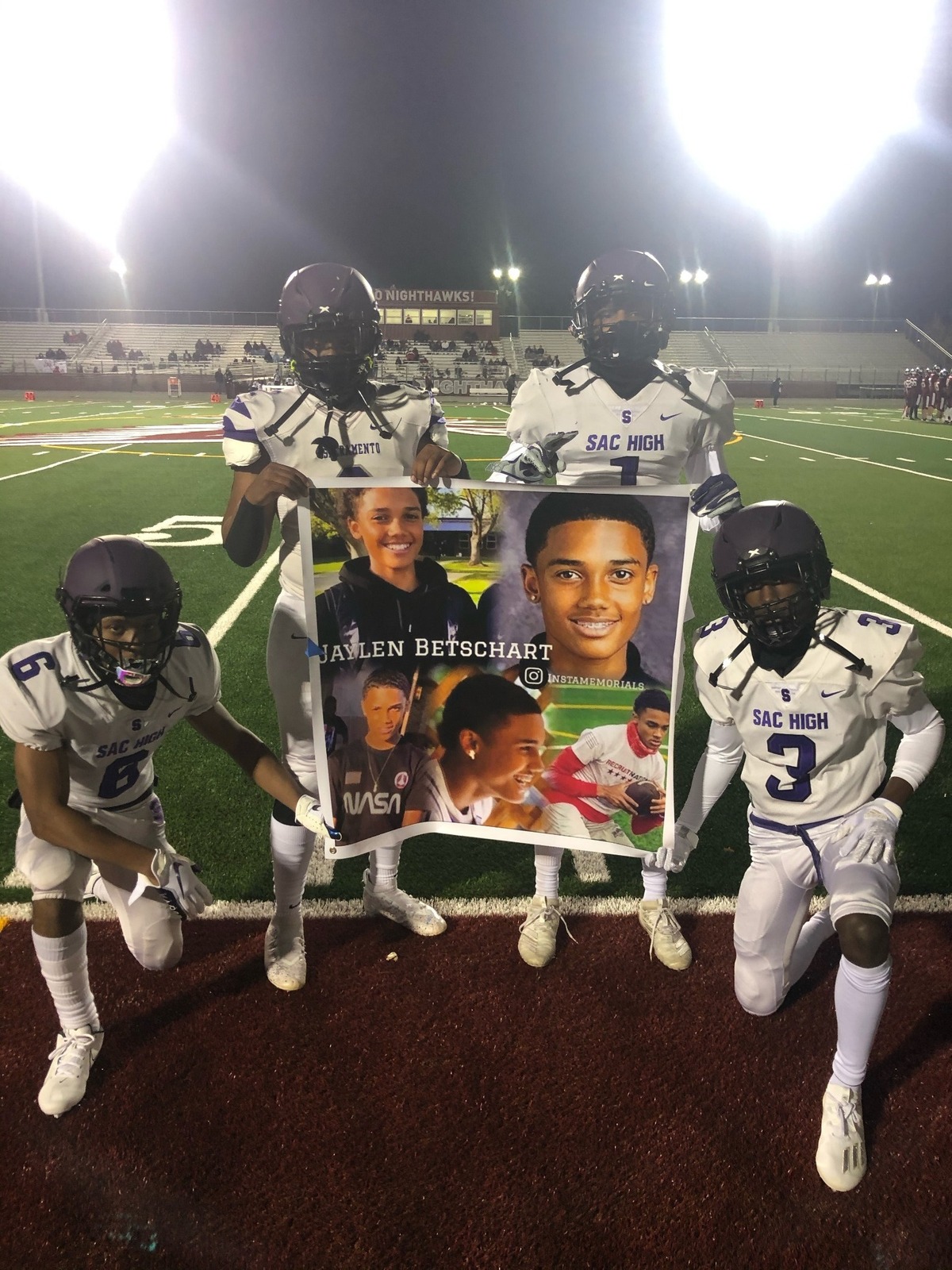 Sacramento High’s seniors hold a banner to honor their fallen teammate, Jaylen Betschart.