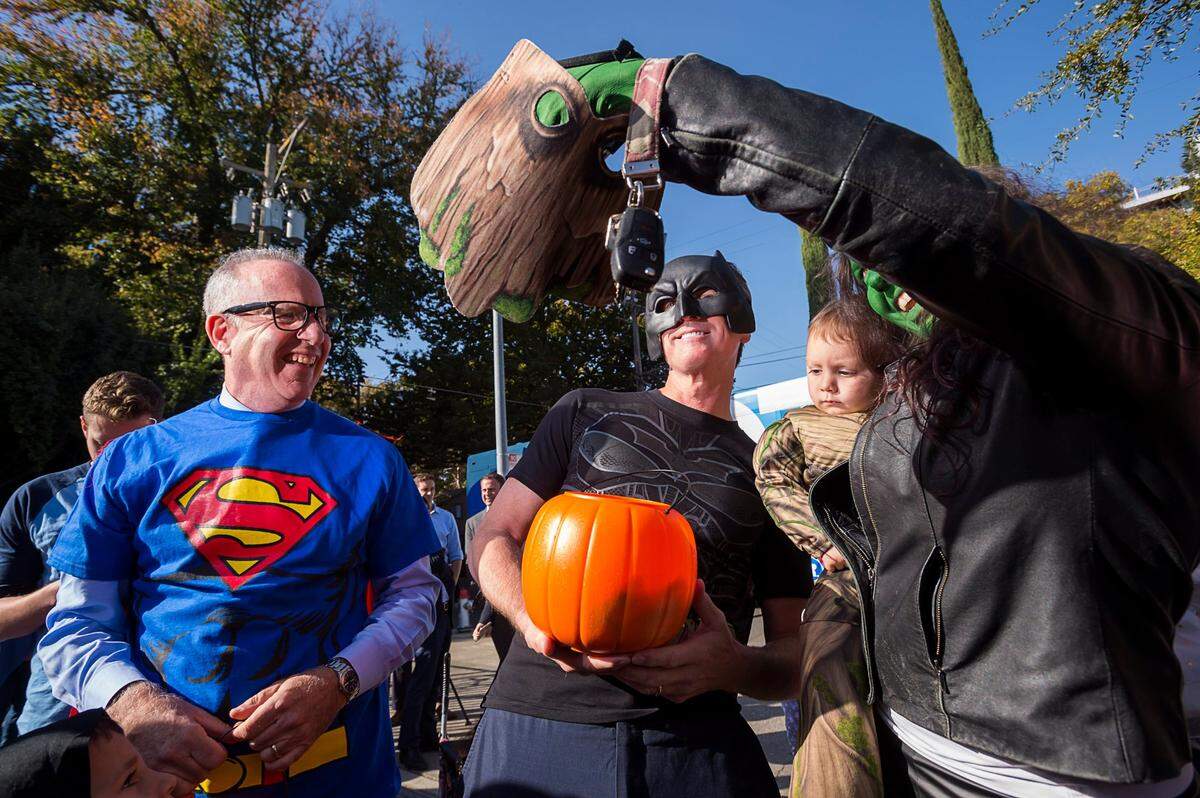 Sacramento Mayor Darrell Steinberg, dressed as Superman, and Lt. Gov. Gavin Newsom, dressed as Battman, greet children attending a Halloween party at the Penleigh Child Development Center in Sacramento on Oct. 31, 2018.