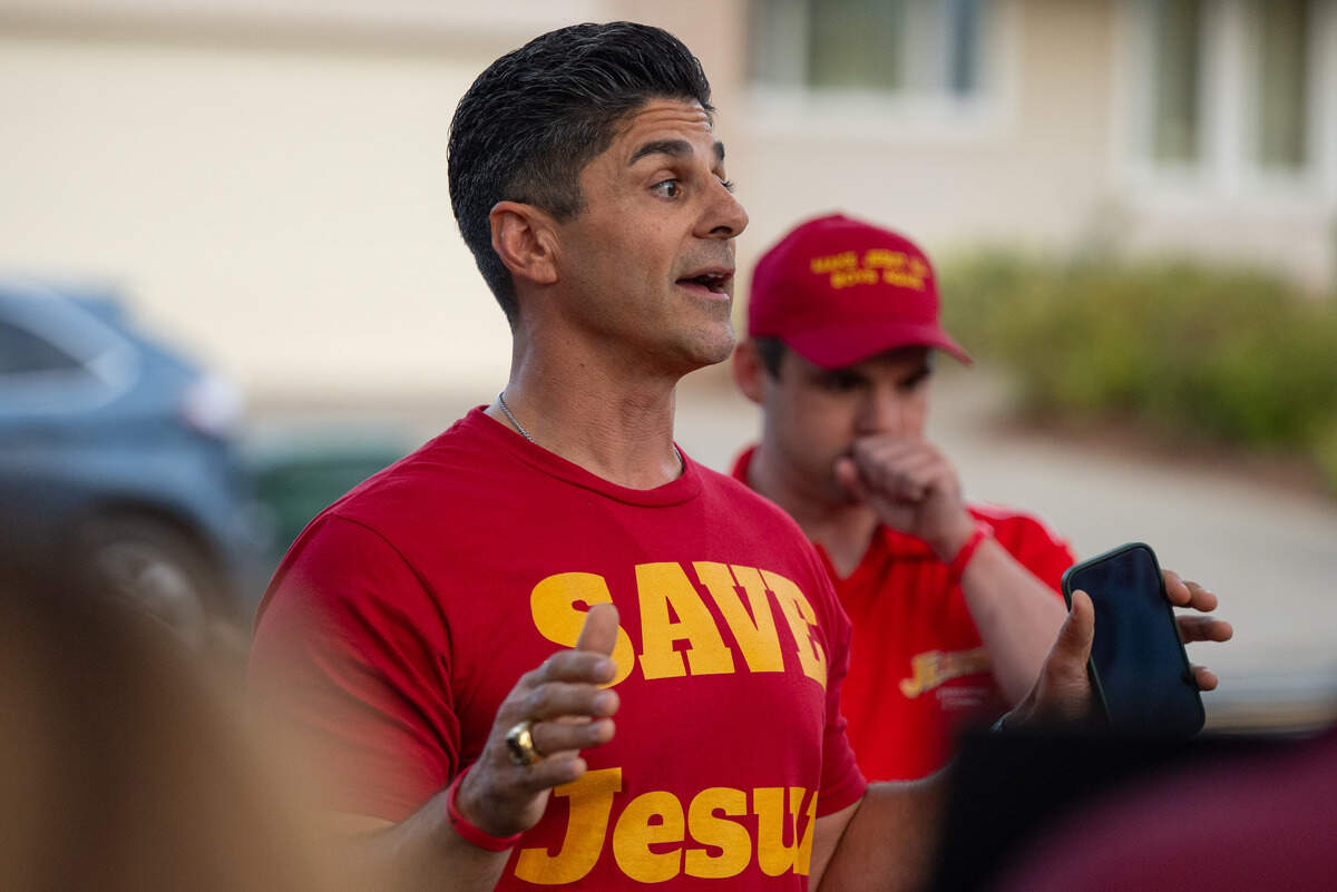Tony Kafouros, a 2000 graduate of Jesuit High School, speaks at a rally Tuesday against the proposal to allow girls to attend the Carmichael high school.