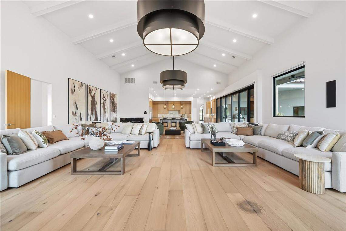 In an epic entrance to the main home, cathedral-style doors and soaring ceilings welcome guests to modern luxury at 9070 Chelshire Estates Court.