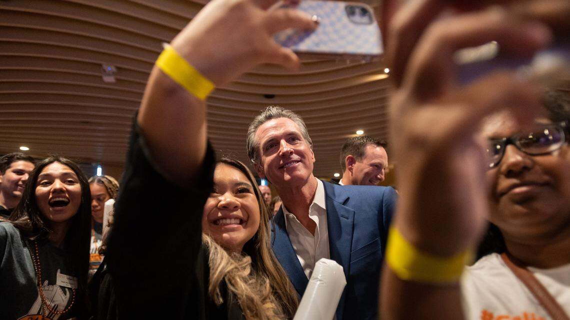 California Gov. Gavin Newsom takes selfies with college students in Sacramento in October 2022. Newsom just visited Florida’s New College and took swipes at Gov. DeSantis.