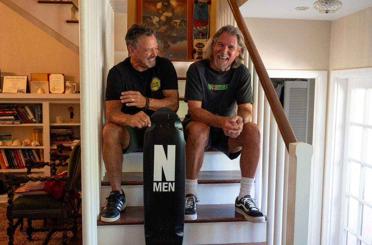 Jeff Will, left, and Jamie Hart sit on stairs at Hart’s home in East Sacramento on Oct. 1. They’re original members of the underground skateboarding crew, N Men, they formed in 1975, that went on to have a global impact on the sport. They are still racing 50 years later.