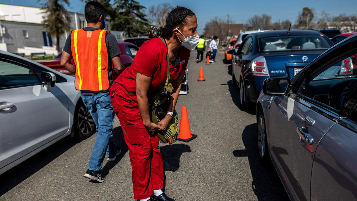 Dr. Kawanaa Carter, the founder of the Del Paso Heights vaccine clinic, checks on vaccinated patients at a clinic that has been vaccinating the hardest hit communities on Thursday, March 4, 2021.