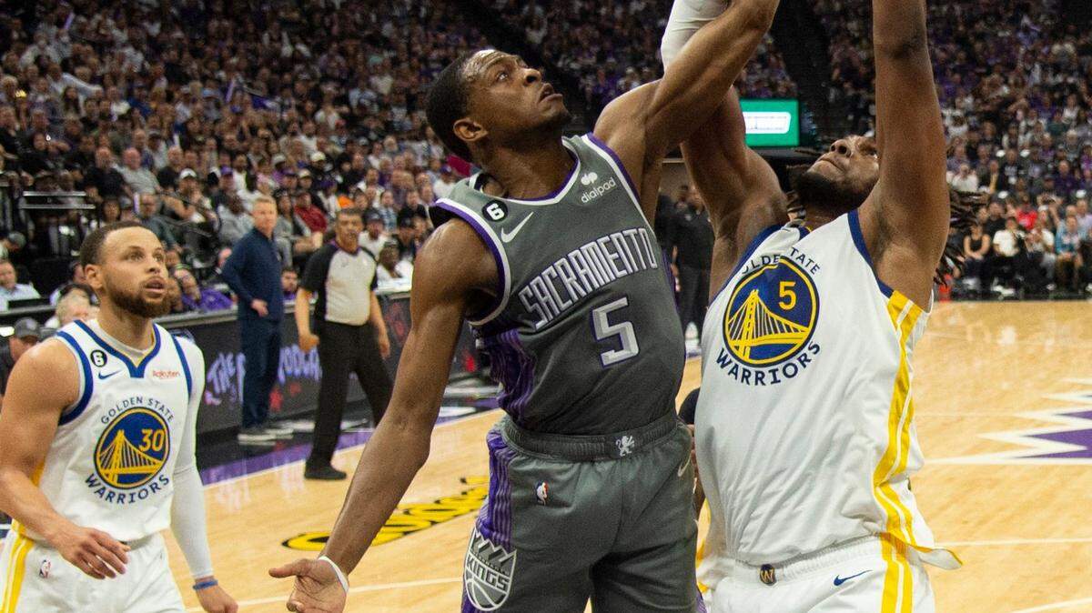 Sacramento Kings guard De’Aaron Fox (5) battles Golden State Warriors forward Kevon Looney (5) for the ball during Game 5 of the first-round NBA playoff series at Golden 1 Center on Wednesday, April 26, 2023.