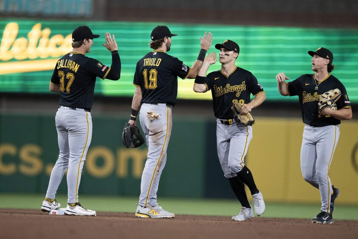 Pittsburgh Pirates congratulate one another after the 12-4 victory Wednesday over the Athletics at Sutter Health Park in West Sacramento.