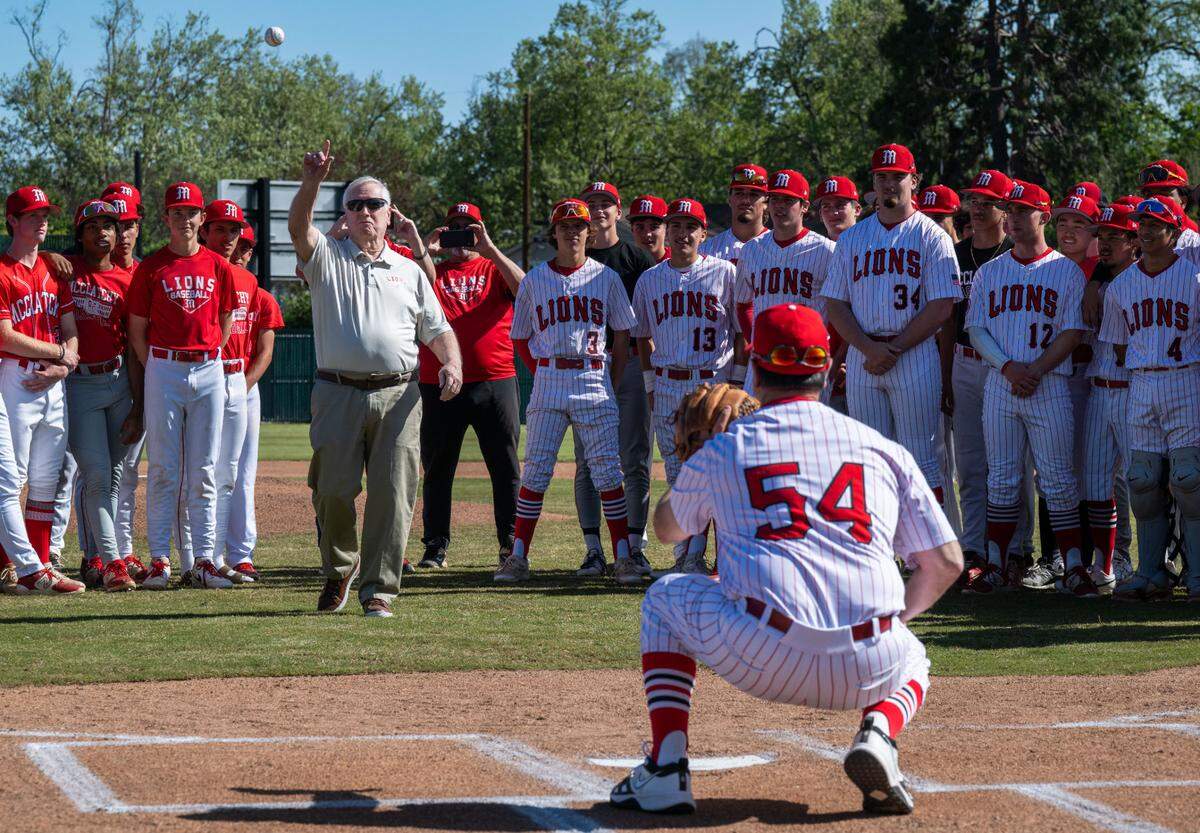 Former McClatchy baseball coach Bernie Church throws the honorary first pitch to the high school’s current coach Michael de Necochea (54), who played for Church, after the official ribbon cutting ceremony for the baseball field on Friday. Church Field, and the new softball facility nearby, were paid for by voter-approved bond funds.
