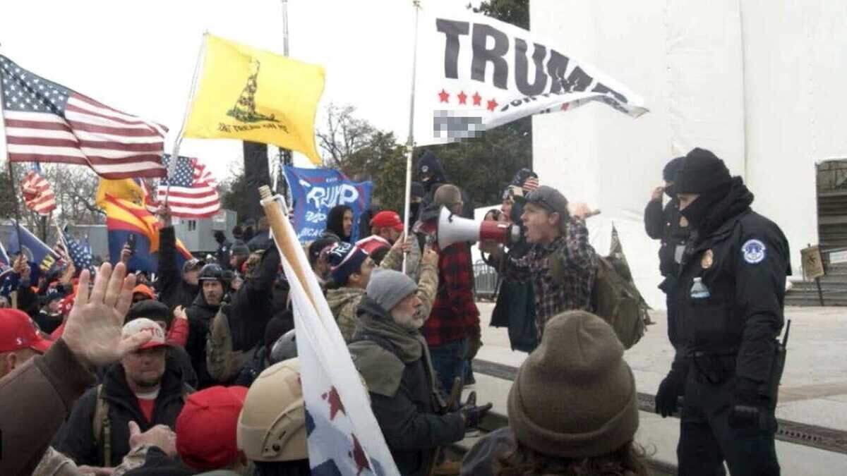 A federal complaint filed against Sean Michael McHugh, 34, of Auburn â seen holding a megaphone in this photo provided by prosecutors â alleges that McHugh sprayed U.S. Capitol Police officers with a chemical substance and assaulted them with a metal sign during the Jan. 6, 2021, insurrection at the U.S. Capitol.
