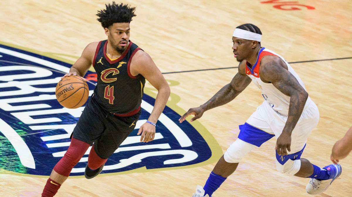 Newly signed Cleveland Cavaliers guard Quinn Cook (4) dribbles around New Orleans Pelicans guard Eric Bledsoe (5) in the first half of an NBA basketball game in New Orleans, Friday, March 12, 2021. (AP Photo/Matthew Hinton)