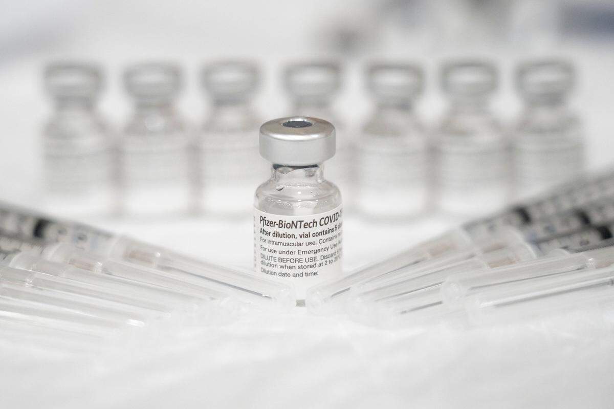 Bottles of the Pfizer COVID-19 vaccine are prepped for use by Mercy Health employee Kelley Williams during a vaccine clinic held by the San Juan Unified School District in partnership with Dignity Health on Saturday, Feb. 20, 2021, at Del Campo High School in Fair Oaks.