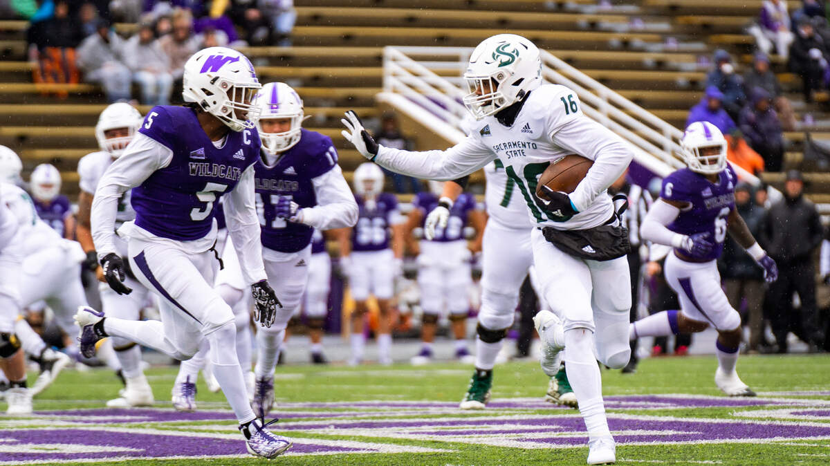 Sacramento State tight end Marshel Martin (16) tries to evade Weber State cornerback Eddie Heckard (5) during the first half of a college football game on Saturday, Nov. 5, 2022, in Ogden, Utah.