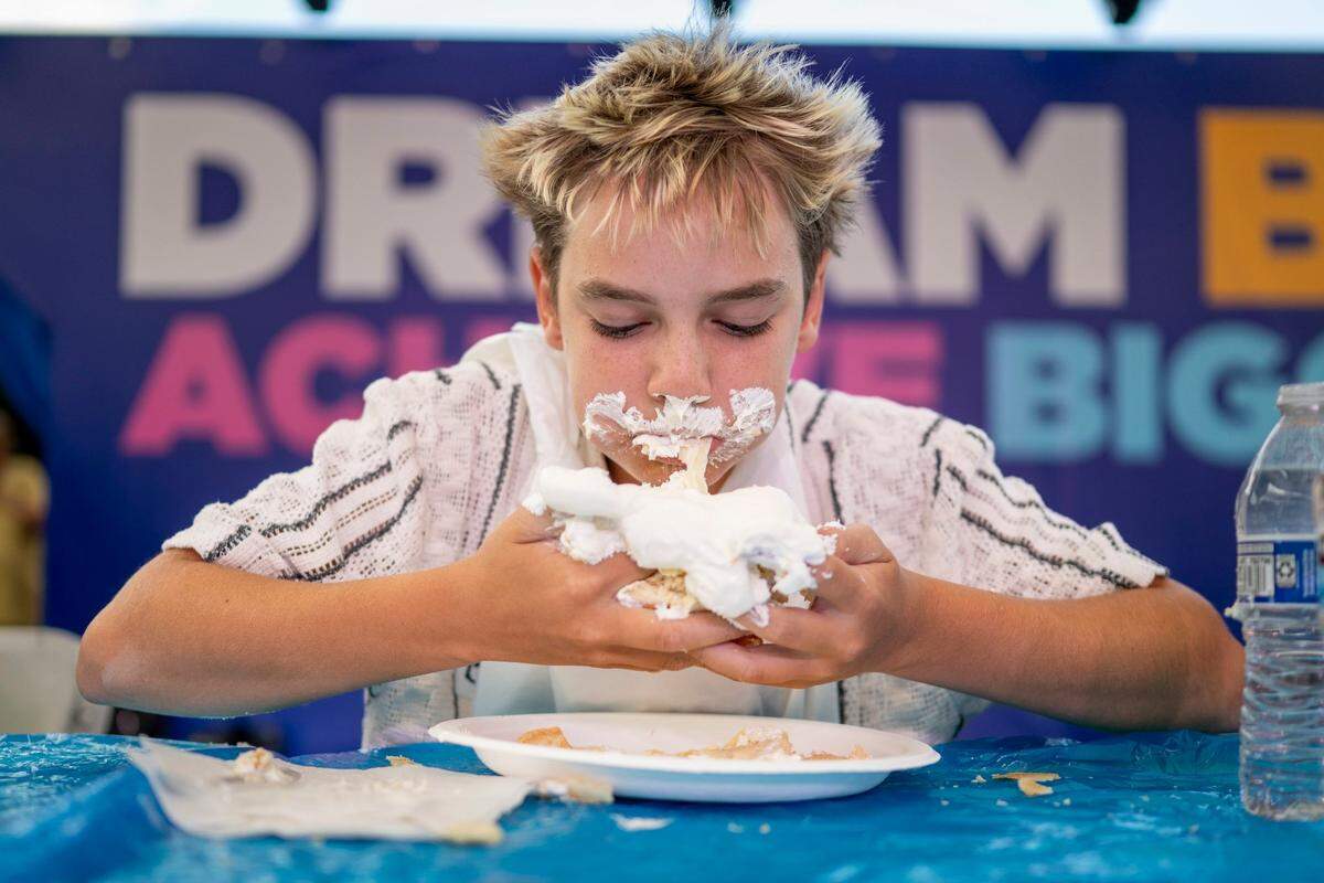 Nikolas Birchman consumes banana cream pie while competing in the teen division of the California State Fair’s pie eating contest in Sacramento on Monday.
