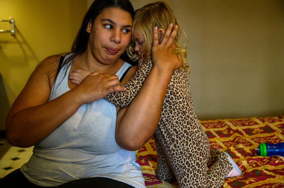 Kalaya Warren, 3, hugs her mother Lane’t Lynn, 24, while staying at Americas Best Value Inn on Friday, Jan. 31, 2020 in Sacramento. “It’s hard to not cry when you have kids. Whenever I cry or something happens she’s like ‘Mommy it’s okay, it’s going to be okay,’” said Lynn about her daughter.
