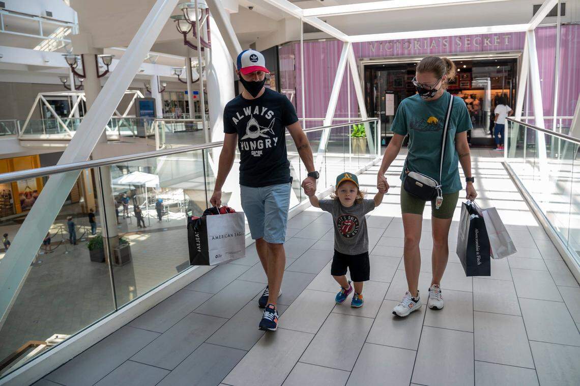 Alex Petrov, left, his son Iaroslav, 3-1/2, and wife Alina shop at Arden Fair mall on Monday, July 13, 2020, the final day of shopping before it temporarily closed again due to rising cases of the coronavirus. Earlier in the day, Gov. Gavin Newsom announced additional closures in the state, including gyms, indoor shopping malls and indoor church worship services.
