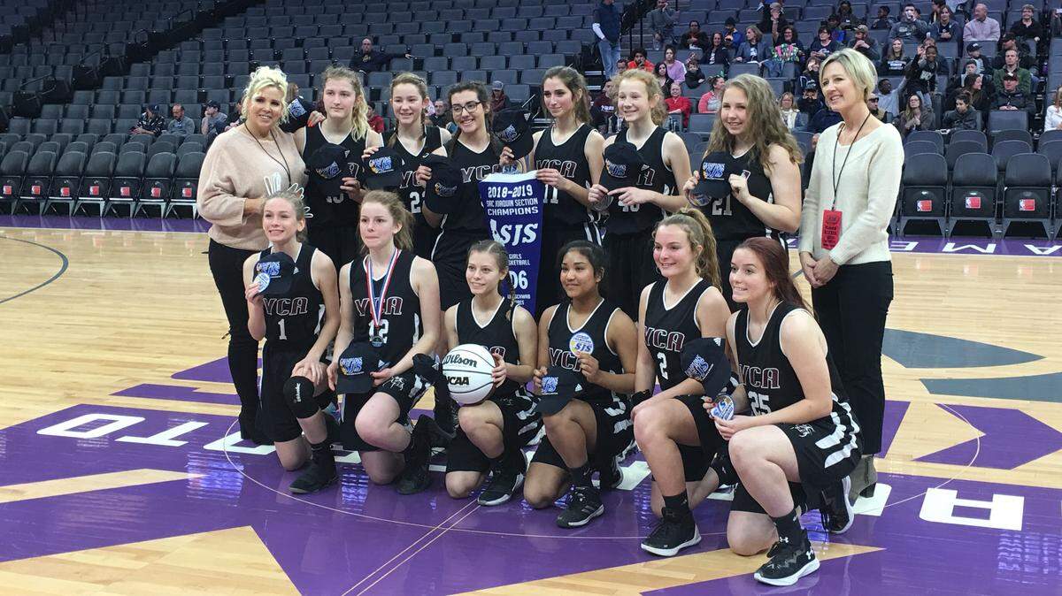 Valley Christian Academy’s girls basketball team poses for a photo at center court at Golden 1 Center after beating Forest Lake Christian on Friday morning to win the Sac-Joaquin Section Division VI championship. It’s the school’s fourth blue banner since 2014.