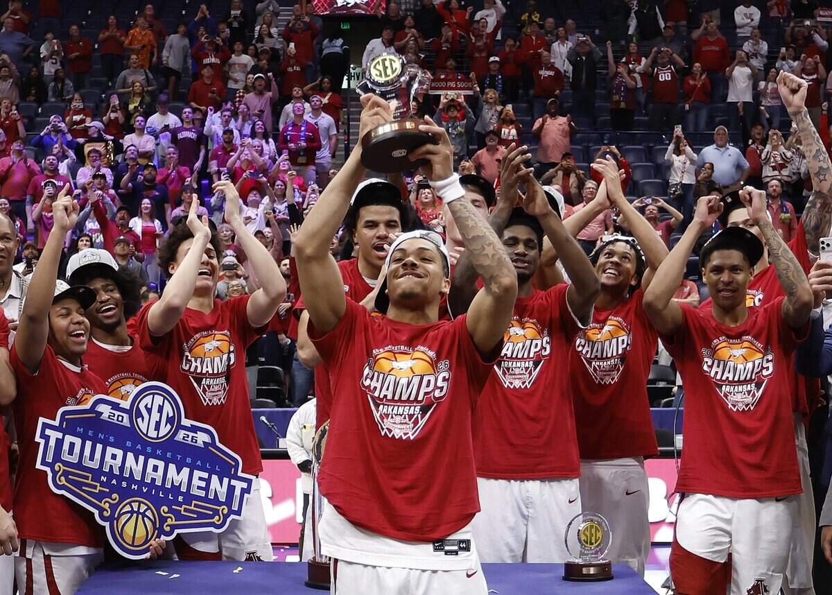 Darius Acuff Jr. (5) of the Arkansas Razorbacks hoists the Most Valuable Player trophy after defeating the Vanderbilt Commodores 86-75 in the 2026 SEC Men’s Basketball Tournament Championship game at Bridgestone Arena on March 15, 2026 in Nashville, Tennessee.