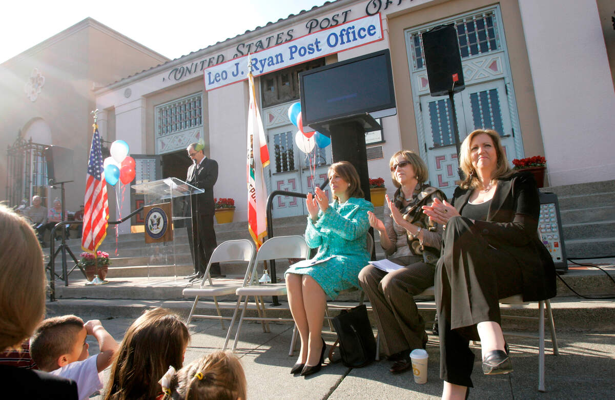 Jackie Speier, D-San Francisco/San Mateo, seated from left, applauds with Pat Ryan and Erin Ryan, daughters of late congressman Leo Ryan, at a ceremony renaming a post office after Ryan, on Monday, Nov. 17, 2008, in San Mateo. Ryan was killed at an airstrip in Jonestown, Guyana in 1978 while investigating the Peoples Temple. Speier was an aide to Ryan and was also shot.