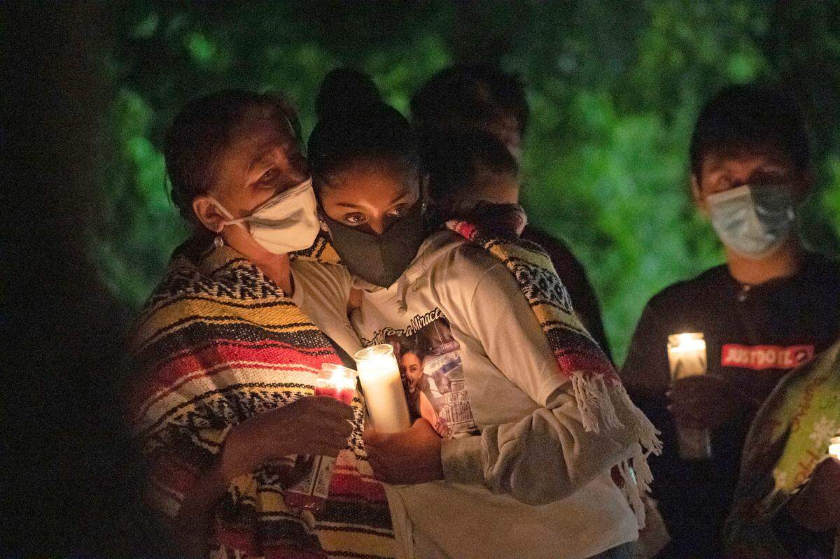 Two woman console eachother at a candlelight vigil for Willie Brown Jr., who was found hanging from a basketball rim in Countryside Community Park in south Sacramento earlier this week, on Friday, Oct. 23, 2020.