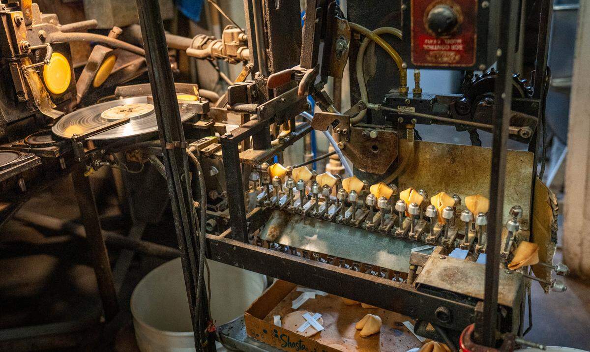 Industrial-sized machines make fortune cookies at New World Co. in downtown Sacramento on Tuesday, April 23, 2024.