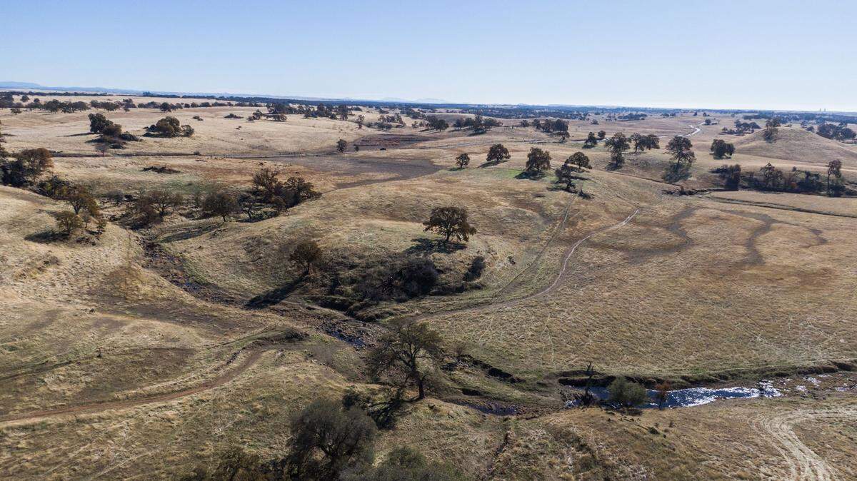 Coyote Creek flows through the rolling hills of eastern Sacramento County near Scott Road in November. A planned project would install solar panels on the site.