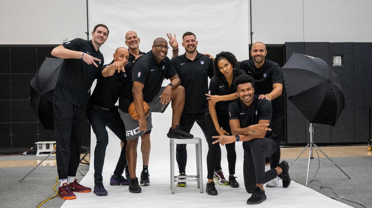 The Sacramento Kings’ new coaching staff, including head coach Mike Brown, center, and former Kings player Doug Christie, second from left, poses for a photo during media day on Monday, Sept. 26, 2022, at Golden 1 Center.