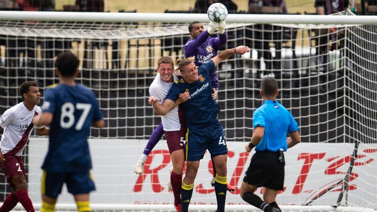 Sacramento Republic FC goalkeeper Rafael Diaz knocks the ball away from the goal on a corner kick as teammate Dan Casey, left, and Real Monarch Aris Briggs vie for position on April 24, 2021, at Papa Murphy’s Park.
