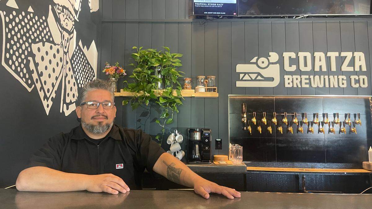 Enrique Silva, owner of Coatza Brewery, stands behind the counter ready for business on Thursday. The new brewery plans a grand opening celebration 10 a.m. to 10 p.m. Saturday.