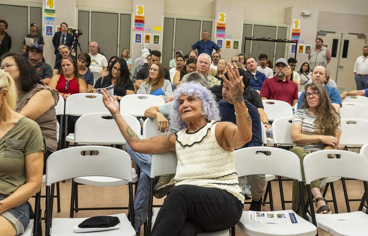 Natomas resident Rosalee Lehr raises her hands in objection as Brian Pedro, director of Sacramento's Department of Community Response, speaks during a community meeting at Witter Ranch Elementary School about a proposed homeless micro-community in the neighborhood in September. 