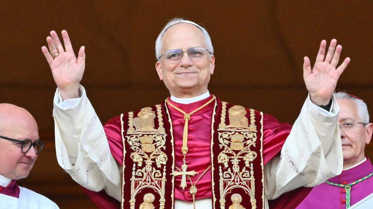 Newly elected Pope Leo XIV, Robert Prevost, arrives on the main central loggia balcony of the St. Peter’s Basilica for the first time on Thursday.