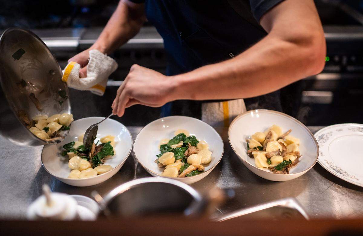 Restaurant Josephine's Mark Looney prepares three plates of potato-leek vareniki in the kitchen during dinner service Tuesday, Sept. 21, 2021, in Auburn.