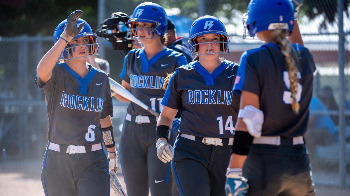 Rocklin High School’s Jamisyn Albin (6) and Jillian Moeller (14) are congratulated by Sydney Barker (5) after scoring in the fourth inning against McClatchy High School during the playoff game in Rocklin on Tuesday.
