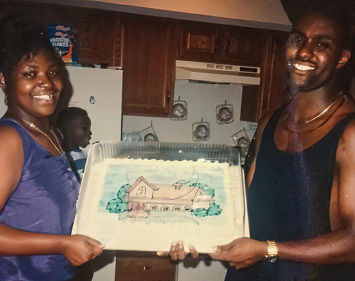 Richard Louis Brown holds a cake with his ex-wife Theresa Brown at a housewarming party at their home in St. Louis in 1994.