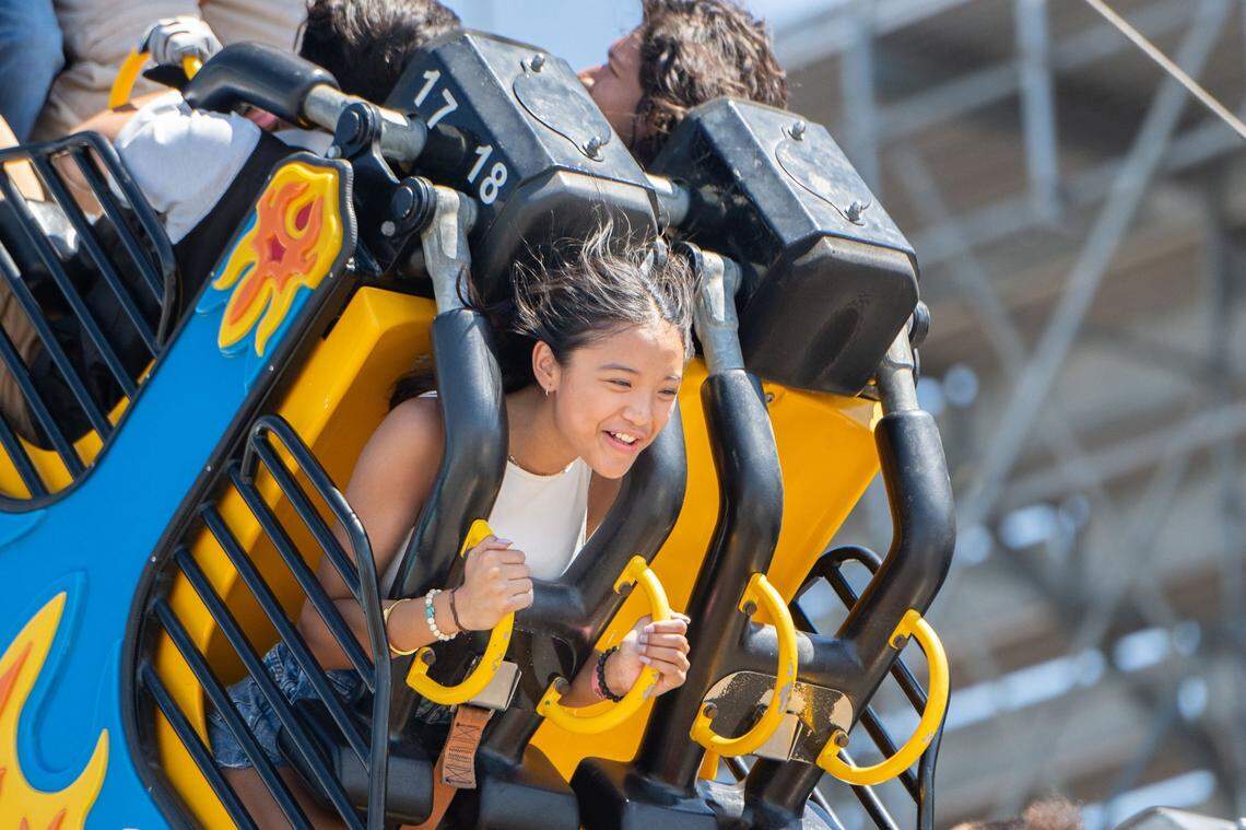 Aleia Deleon, 13, holds onto the handles of the Ring of Fire at the California State Fair in Sacramento on Tuesday, July 16, 2024. “I liked being upside down,” Deleon said.