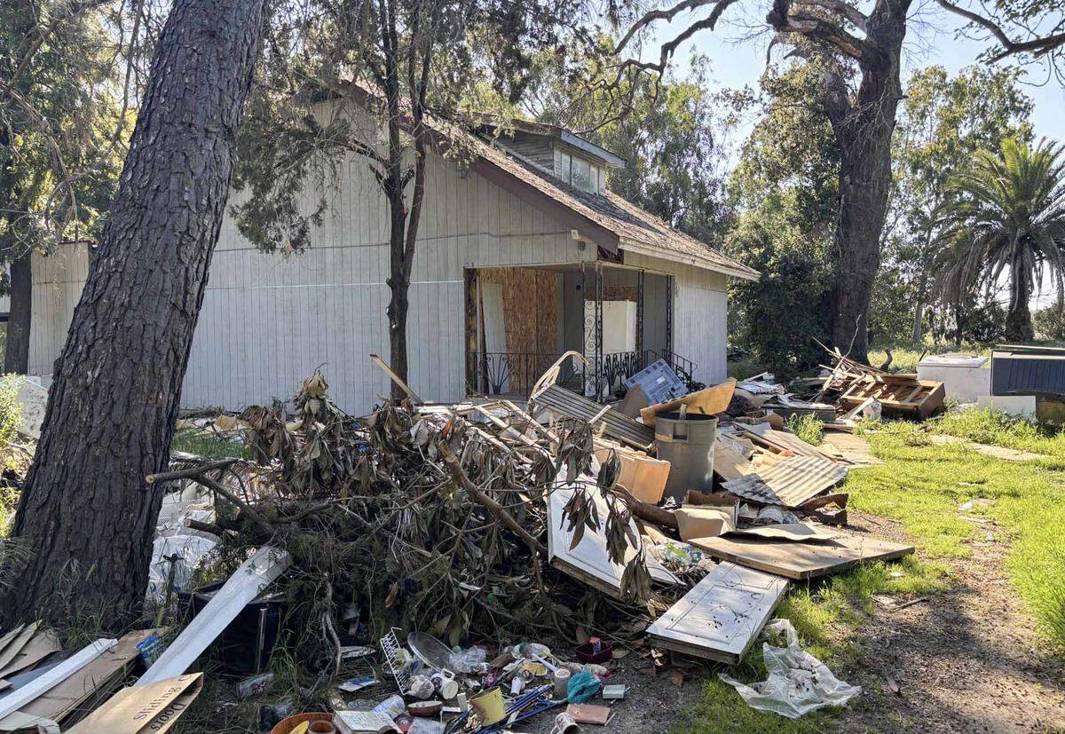 Trash and debris litters the yard at 8932 Florin Road in Sacramento County in March. The boarded up home on a 1-acre parcel was sold at a tax auction for $410,051 in May 2025.