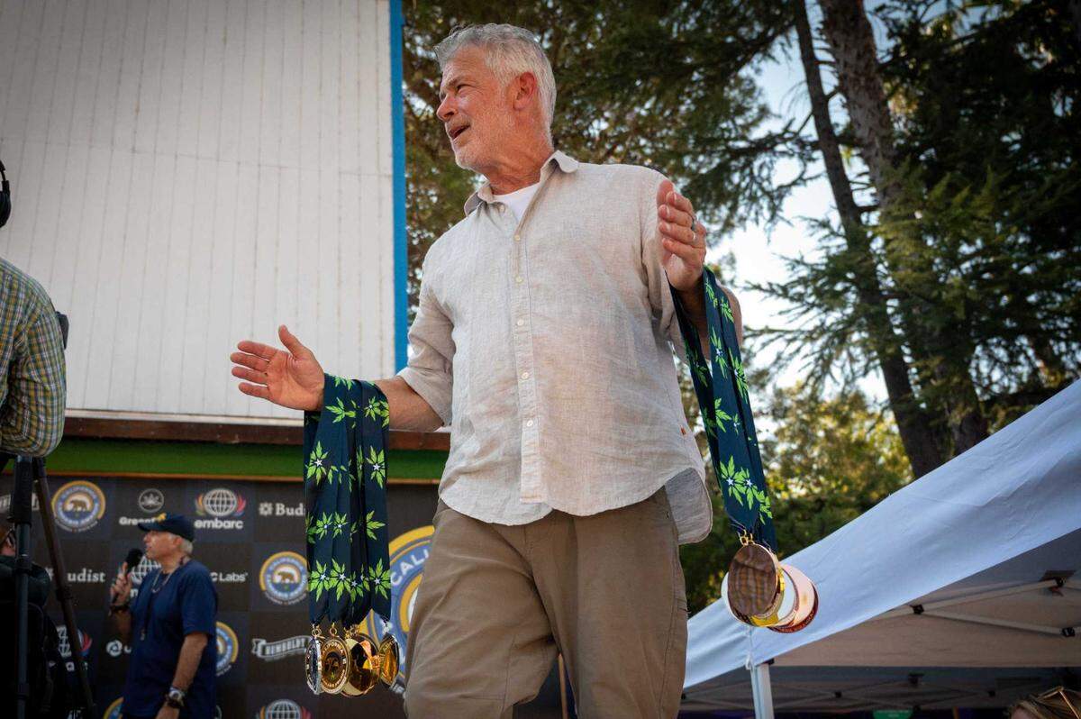 James Leitz, co-producer of the Cannabis Experience and awards show, carries stacks of medals at the California Cannabis Awards at the California State Fair on Saturday, July 12, 2025 in Sacramento.