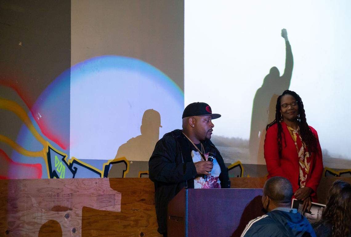 Jamal Dupree, older brother to Sacramento native Tyre Nichols, speaks during a memorial and celebration of life at Sac Ramp Skate Shop on Feb. 4 for Nichols, who was beaten by Memphis police in January and later died. Nichols holds his fist in the air in the photo projected behind him.