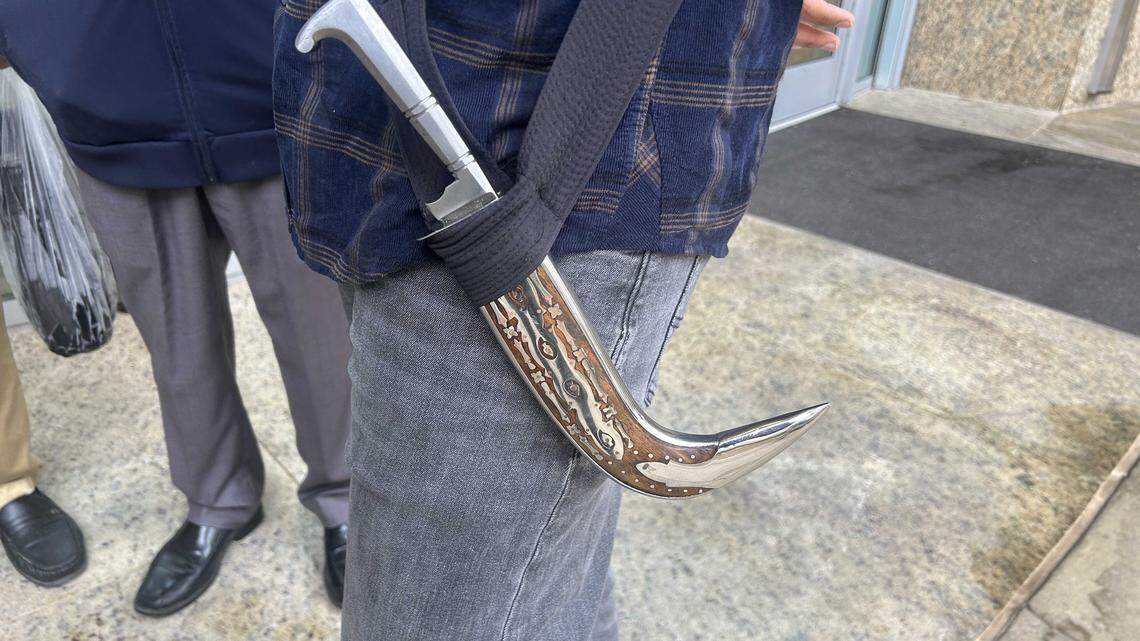 A man carries a kirpan, a religious blade worn by initiated Sikhs, outside of City Hall on Tuesday, October 14, 2025. The City Council will likely approval a proposal to allow kirpans inside city facilites.